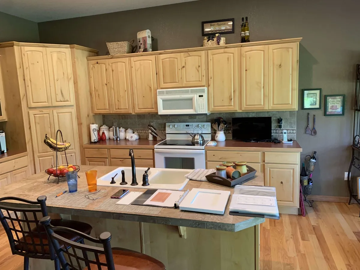 Before — Knotty wood to bright white, blue-grey island