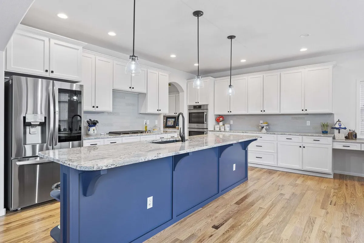 After — Honey-toned wood to crisp white, navy island